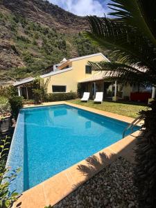 a swimming pool in front of a house at Suite Vigia Jardim in Jardim do Mar +83 photos