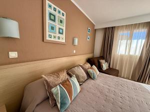 a bedroom with a bed with pillows on it at Hôtel Restaurant L' Empereur in Aléria +49 photos