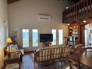 ein Wohnzimmer mit Sofa und Fernseher in der Unterkunft Blue Pearl Villa in St John USVI in Coral Bay