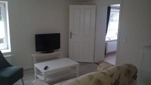 a living room with a couch and a tv at Ferienwohnung Nähe Altstadt in Sassnitz