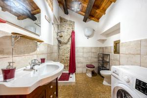 a bathroom with a sink and a toilet at Casa Puggimiano in Poggio Moiano +17 photos