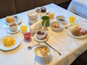 a table with breakfast foods and drinks on it at Pension Atlantic in Badia