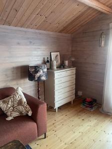 a living room with a couch and a dresser at Sørstraumen View in Nordstraumen