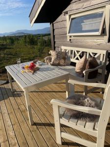a white picnic table and two chairs on a deck at Sørstraumen View in Nordstraumen