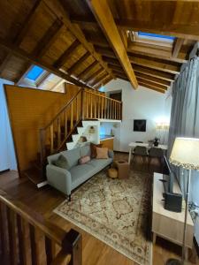 a living room with a couch and a staircase at A casa do cervo in Vila Nova de Cerveira +15 photos