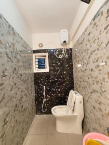 a bathroom with a toilet and a wall with fish tiles at Homestay 2BHK, 3BHK, 4BHK, 5BHK call 8O8823-7972 in Narasimharaja Puram