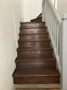 a stairway with wooden steps in a house at T1 a loué centre ville de Guéret in Guéret