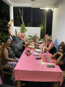 a group of people sitting around a pink table at Ceylon Sungarden in Habaraduwa Central
