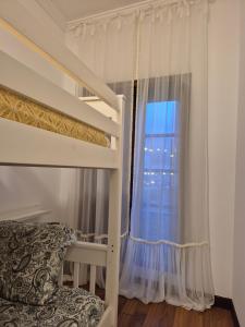a bedroom with two bunk beds and a window at A casa do cervo in Vila Nova de Cerveira