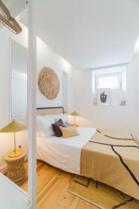 En eller flere senge i et værelse på Ajuda Cozy Retreat with Patio