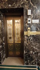 a pair of doors in a room with stone walls at Hotel Claytone Near Delhi Airport in New Delhi