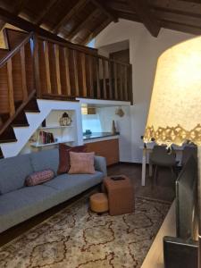 a living room with a blue couch and a staircase at A casa do cervo in Vila Nova de Cerveira