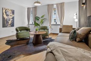 a living room with a couch and chairs and a table at 3 Queen Beds Waterfall Garage Terrace Center in Saarburg