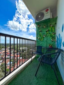 a balcony with a table and chairs and a view at Meraki Space Mactan Cebu in Lo-oc
