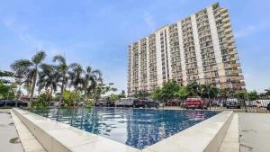 a large apartment building with a large swimming pool at Meraki Space Mactan Cebu in Lo-oc