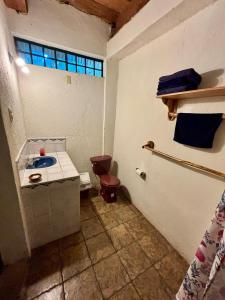 a small bathroom with a toilet and a sink at Paradise of Atitlan in Santiago Atitlán