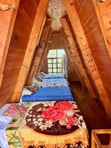 a attic room with three beds with flowers on them at Paradise of Atitlan in Santiago Atitlán