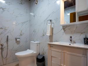 un baño con inodoro y lavabo en Puthooram Seaview Cliff Resort, en Varkala 19 fotos más