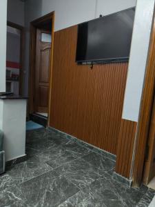 a room with a wall with a flat screen tv at Younes residence in Asilah