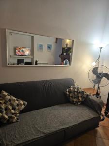a couch in a living room with a mirror at Luisina 78 ONLY ADULTS in Viareggio