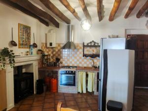 a kitchen with a refrigerator and a stove at Casa Mirador in Cáñar