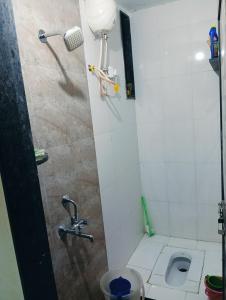 a bathroom with a shower and a toilet at Sukhada Nivas Bunglow in Trimbak +10 photos
