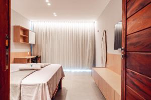 En eller flere senge i et værelse på Apartamentos Barra Grande - APEBG