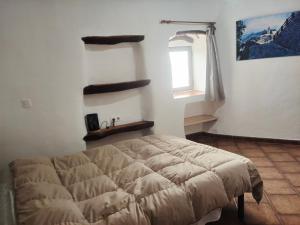 une chambre avec un lit dans une pièce avec une fenêtre dans l'établissement Casa Mirador, à Cáñar