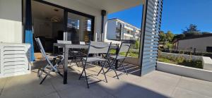 a patio with a table and chairs on a balcony at Joli T2 cozy, proche plages, Terra Doru B02 in Propriano +41 photos