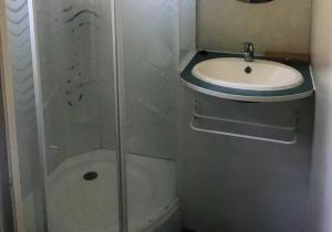 a small bathroom with a sink and a shower at Camping 3 étoiles - Piscine - ccbccbe in Sartène +40 photos