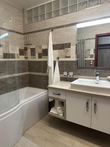 a bathroom with a tub and a sink and a bath tub at Apartmán U3 in Týniště nad Orlicí +20 photos