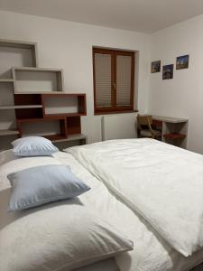 a bedroom with a large white bed with two pillows at Apartmán U3 in Týniště nad Orlicí +20 photos