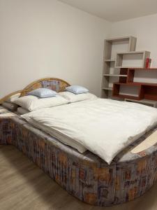 a large bed in a bedroom with a large mattress at Apartmán U3 in Týniště nad Orlicí