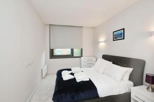 a bedroom with a large bed and a window at Modern 1 Bed Apt Bracknell- with parking in Bracknell +16 photos