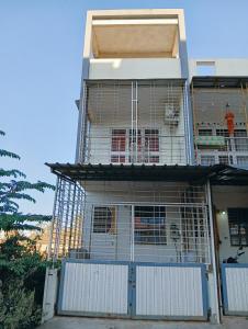 a building with a bird cage on the front of it at Sukhada Nivas Bunglow in Trimbak