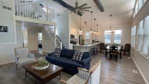 a living room with a blue couch and a table at Sandy Shores in Union Pier