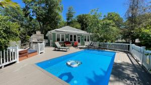 a swimming pool on a deck with a house at Sandy Shores in Union Pier