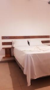 En eller flere senge i et værelse på Apartamentos Nova Caraiva