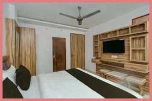 a bedroom with a bed and a flat screen tv at Hotel Shree Jyotirmay Residency in Kankhal