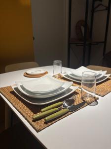 a table set with plates and utensils on a table at Panta Rei 97 in Barletta
