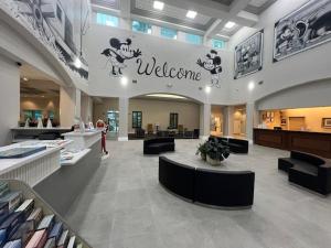 a lobby with a welcome sign in a store at Disney 1st floorEpicFREE ShuttlePARKINGNO FEES in Orlando