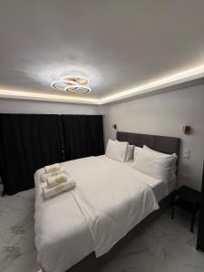 a bedroom with a large bed with towels on it at City Center Lux Studio in Athens