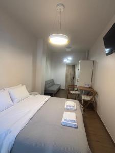 Storks apartments في كورينوس: غرفة نوم بها سرير كبير عليه منشفتين