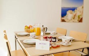 a table with plates and cups and drinks on it at Casa Orchidea in Botricello +2 photos