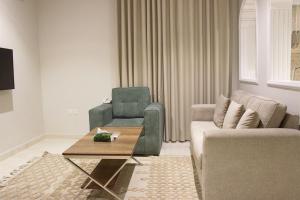 a living room with a couch and a chair at النسمة الهادئة in Jeddah