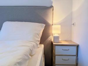 um quarto com uma cama e uma mesa de cabeceira com um candeeiro em Treehouse - Alpinlake Apartments em Grünau im Almtal