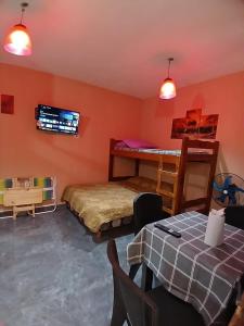 a room with two beds and a bunk bed at Monoambiente San Bernardo in San Bernardo