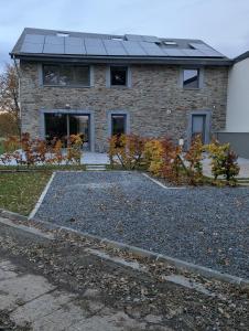 a house with solar panels on top of it at La Petite Reine in Bertrix