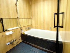 a bathroom with a bath tub in a room at Hotel Imagine Kyoto in Kyoto
