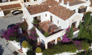 an aerial view of a white house with purple flowers at VILLA AMIRA ,Marbella Estepona in Benahavís